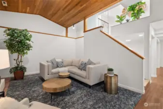 LOWER LEVEL LIVING | Check out this rec room! There is so much space to spread out, host get-togethers, and entertain. Down the hallway in the right side of the photo are more rooms for multiple uses.