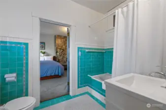 This large adjoining bathroom connects two of the bedrooms. Note the gorgeous original tilework that has been lovingly maintained.