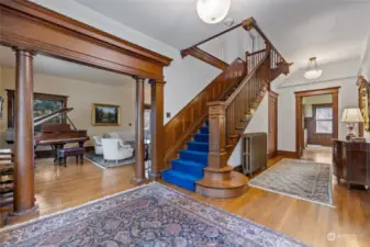 The large foyer opens to the living room, dining room, kitchen and grand staircase.