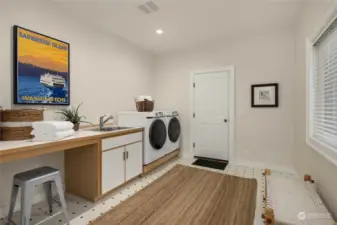 Main floor laundry/mud room with access to the attached 3-car garage