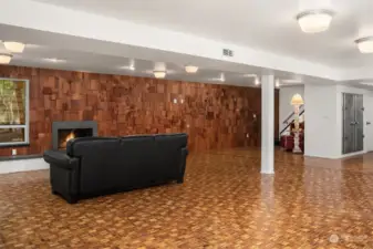Lower level great room with wood tile floor and redwood shingle sculptural wall