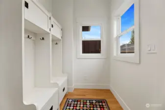 The epitome of convenience, this bright and beautiful "mudroom" is just off the kitchen and leads to the back yard and garage. (Organizational cupboards here may convey if desired.)