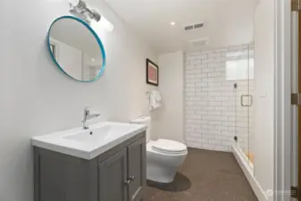 Another beautifully designed bathroom, this lower level 3/4 bath has Jack-and-Jill entrance from the family room and laundry room. Heated floors in this bathroom as well!