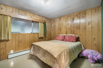 The second bedroom features paneling and privacy glass in the windows. Bedrooms feature cedar-lined closets.