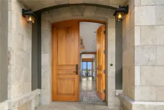 Gorgeous main entryway w/ custom crafted, hand-hewn double doors made of 2.25 inch thick, solid plank walnut.