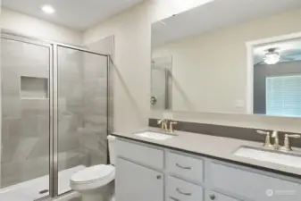 Beautiful master bathroom offers storage space, large walk-in shower, and dual sink vanity.