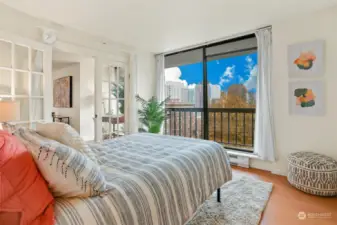second bedroom with adjacent deck and city views.