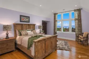 One of the spacious bedrooms that offers a water and mountain view.