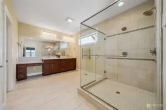 Primary bath w/vanity, extended shower w/dual heads, and even a heated towel bar. Floors are heated too.