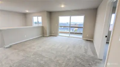 Bonus Room on Upper Level with slider to covered deck  - Photos from finished Ellington on another lot in community. Finishes and options will vary.