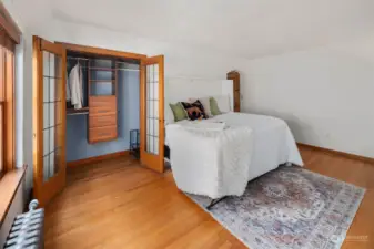 Spacious closet space and studio living area with murphy bed