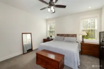 Primary Bedroom ~ Natural lighting ~ Ceiling fan light ~ Wood Blinds ~ Walk-in Custom Closet