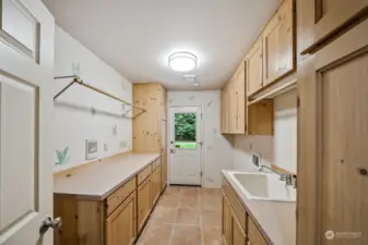 Mudroom/laundry room will not disappoint, even if you don't even like doing laundry! Lots of cabinet space, folding area, hanging rack, deep sink & door leading out to the gardening shed.