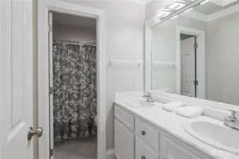 The upper level bathroom offers a tub/shower arrangement that is separate from the double sink vanity for added convenience when sharing the space.