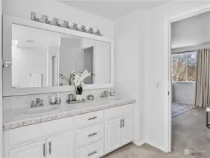 5 piece bathroom in the primary suite features double sinks, large soaking tub, walk-in shower, and a skylight.