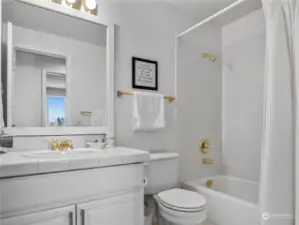 This full bathroom is located just steps away from the additional 3 bedrooms.