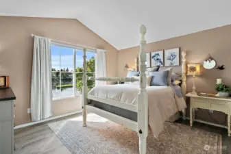 This remodeled primary ensuite has vaulted ceilings, LVP easy care flooring, the "best view in the house windows" overlooking the lake, a 5-piece bath, and 2 walk-in closets, including the larger "celebrity closet",   with French doors.