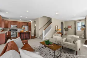 A thoughtfully designed floor plan features a spacious kitchen seamlessly flowing into a great room. The dining room, positioned conveniently adjacent to the kitchen, offers a touch of privacy while maintaining easy access for food preparation.