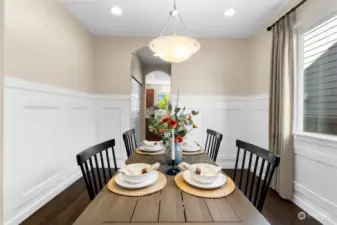 Crisp white wainscoting add an elegant traditional touch to the dining area where you can create memories with your loved ones.
