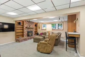 Large family room located downstairs. You'll love the gas fireplace insert to keep you comfy.  There are baseboard heating in this room, but seller doesnt use it since gas furnace was installed with proper venting.