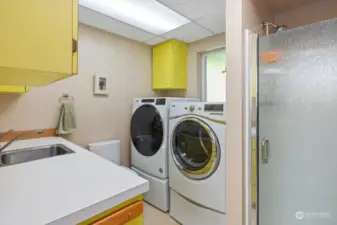 Laundry conveniently has a laundry shoot from above, which lands in a cabinet.  There is a toilet, sink and shower conveniently located in the laundry area.