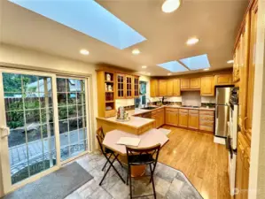 Built in eating area with tile floor and skylight above.  The slider opens to the side paver patio with access to the RV carport and backyard.