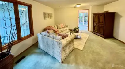 The family room is located just off the entry with wood burning fireplace, wood wrapped, leaded & beveled windows and access off the kitchen and entry way.