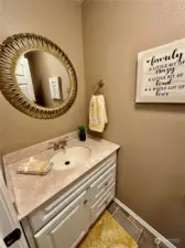 The convenient powder room is located just off the laundry area and close to both the garage and kitchen nook.