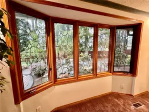 Close up view of the beautiful wood wrapped bay windows that offer lovely views of the pond and rear yard.