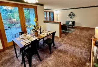 The dining room is centrally located between the kitchen and living room with beautiful lead/beveled French doors that open to the rear patio and backyard.