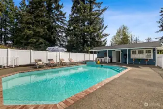 Adjacent to the pool, a charming pool house awaits with full kitchen, bar seating and 3/4 bath, providing a sanctuary for relaxation and entertainment. Imagine hosting unforgettable gatherings where laughter fills the air and memories are made.