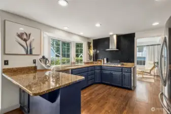 The spacious kitchen is light filled with an abundance of windows that overlook the back yard. Pull up your stool to the eating bar or enjoy the kitchen eating nook for casual dining.