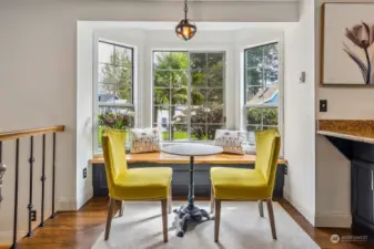 Just off the kitchen you'll love this casual eating area with lovely, wood topped window seat that overlooks the backyard oasis, complete with NW hardy palm trees!