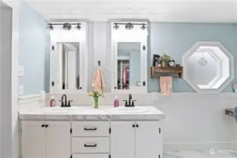 Double vanity with lots of storage and vanity cabinet mirrors.