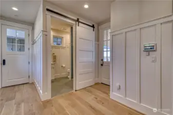 Here is the mud room located off the kitchen. Here you have access to the 3/4 bath that is located just off the pool patio. The door ahead accesses the breezeway to the garage, and the door on the right accesses the covered outdoor seating area and pool.