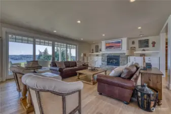 Here is the great room located just off the entry. Of course the view is front and center as it is in most rooms. And you will appreciate the custom built ins, commercial grade white oak wide plank flooring. And if that looks familiar, you are a Nordstrom shopper!