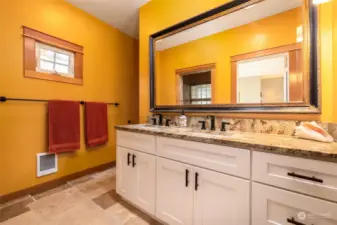 Primary bath with large walk-in shower and double sinks.