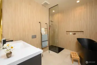 Primary suite bathroom w/ Japanese soaking tub, walk in shower and heated floors