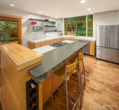 Thick edged basalt & quartz countertops, built in island cabinet with wine rack