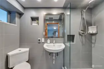Lower level bathroom boasts sleek updates and radiant flooring in an efficient package