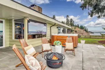 The expansive patio features plenty of space for outdoor dining and cedar hot tub for an ideal perch to take in the views or entertain