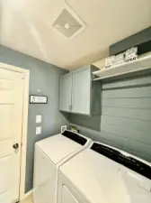 Laundry area with built-ins for extra storage.