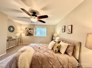 Spacious primary bedroom with a ceiling fan for added comfort.