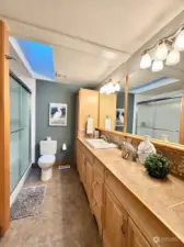 Primary bath with a large step-in shower. An abundance of cabinetry provides lots of storage space.