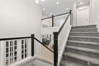 Beautiful staircase leads to the loft and upper level bedrooms.