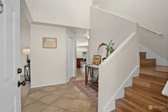 Impressive grand foyer with soaring ceilings. Lovely curved staircase to upper level.