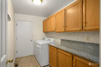 Large Laundry leading to garage with tons of cabinets