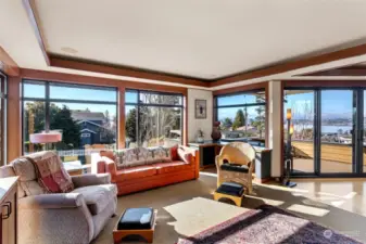 Spacious Upstairs Living Area With Awesome Views Out Over Lake Washington Towards The University of Washington.  Soothing Up-Lighting Encased In Cherry Wood Ceiling Valances.  The Up-Lighting Runs Throughout The Home.