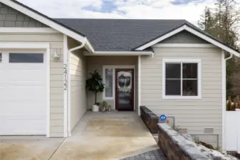 This home has a wonderful upgraded modern front door with additional screen door and covered area.
