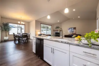 The spacious living area seamlessly flows into the dining space and kitchen, creating a dynamic and inviting atmosphere that encourages socializing and connection.